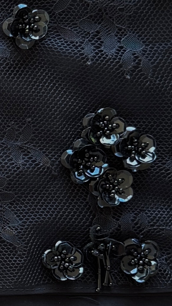 Black lace fabric with floral embellishments